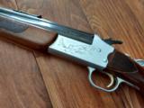 SAVAGE M-24 DELUXE, 22 LR. OVER 410 GA. WHITE OUTLINED CHECKERED WALNUT WOOD, GOLD TRIGGER, SATIN SILVER ENGRAVED RECEIVER - 2 of 6