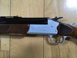SAVAGE 24 DELUXE, 22 LR. OVER 410 GA., SATIN SILVER ENGRAVED RECEIVER WITH RED FOX ON ONE SIDE AND GROUSE IN FLIGHT ON OTHER SIDE, EXC. COND. - 2 of 9