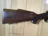 WINCHESTER 70 DELUXE 22-250 CAL., HAS JEWELED BOLT, HAS FANTASTIC FIDDLE FIGURE MONTE CARLO WALNUT WOOD, 99+% COND. IN THE BOX - 2 of 12