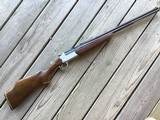 SAVAGE 24 DL, 22 MAGNUM OVER 410 GA. DELUXE, MONTE CARLO, CHECKERED WALNUT STOCK, GOLD TRIGGER, SATIN SILVER RECEIVER WITH GROUSE IN FLIGHT & RED FOX
