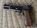 SOLD———-BROWNING BELGIUM HIGH POWER 9 MM, MFG. 1970, RING HAMMER, COMES WITH BROWNING ZIPPER CASE WITH RED INTERIOR ALL IN HIGH
CO ND. - 3 of 4