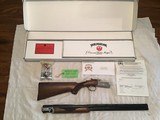 RUGER RED LABEL “50TH ANNIVERSARY 1949-1999” 28 GA. ENGRAVED WITH GOLD WOOD COCKS ON THE RECEIVER, NEW UNFIRED IN THE BOX WITH PAPERS, CHOKE TUBES