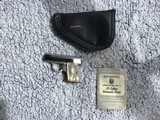 BROWNING BELGIUM BABY 25 AUTO, BRIGHT NICKEL, GOLD TRIGGER & PEARLITE GRIPS, NEW UNFIRED IN THE BROWNING
ZIPPER POUCH WITH OWNERS MANUAL