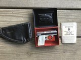 BROWNING BABY 25 AUTO, BRIGHT NICKEL, GOLD TRIGGER, PEARLITE GRIPS, IN THE BOX WITH OWNERS MANUAL & BROWNING ZIPPER POUCH ALL NEW COND.