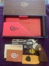 COLT PYTHON 4
BRIGHT NICKEL, NEW UNFIRED IN THE BOX WITH OWNERS MANUAL, HANG TAG, COLT LETTER, COLT SCREW DRIVER, ETC.