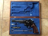 SMITH & WESSON 29 NO DASH 44 MAGNUM 6 1/2” BLUE, IN SMITH WOOD PRESENTATION CASE WITH CLEANING TOOLS, 99% COND. POSSIBLY UNFIRED - 1 of 9