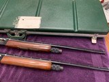 REMINGTON 1100 MATCHED SKEET SET, 28 GA. & 410, MFG. 1969, 25” SKEET CHOKES, EXC. COND. COMES IN ORIGINAL REMINGTON GREEN CASE WITH WEIGHTS - 1 of 5