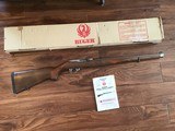 RUGER 10-22, 22LR. INTERNATIONAL CHECKERED
MANLICHER WALNUT STOCK, STAINLESS STEEL, NEW UNFIRED IN THE BOX WITH OWNERS MANUAL, ETC.