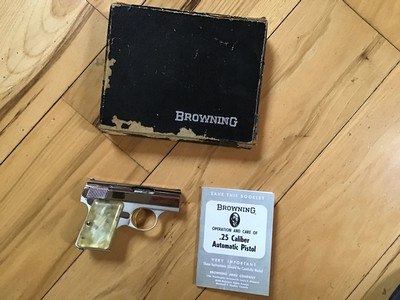 BROWNING BABY 25 FACTORY BRIGHT NICKEL WITH PEARLITE GRIPS NEW IN THE BROWNING BOX WITH OWNERS MANUAL - Image 1 of 3