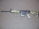 DPMS MODEL A-15 (M4 TACTICAL CARBINE) IN 5.56 WITH MAGPUL MOE CAMO FURNITURE - 1 of 5