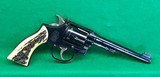 Pre-war S&W Outdoorsman in 22 LR. Hump back hammer and synthetic bone grips. - 1 of 4