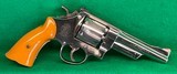 S&W pre-26 model of 1950, nickle with rare 5 inch barrel and Catalin grips.