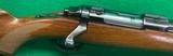 Early flat bolt, tang safety Ruger M77 in 308 with sights.