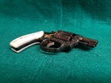Smith & Wesson - MODEL 36 FLAT LATCH - BEAUTIFULLY ENGRAVED BY CECIL MILLS W-GOLD INLAYS. REAL PEARL GRIPS. MFG. CIRCA 1950-1969 - .38 Special - 21 of 25