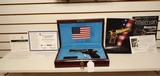 Used Un-fired Colt 1911 45 acp
American Eagle in Gold and Blue with wooden display case - 5 of 25
