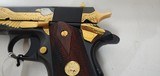Used Un-fired Colt 1911 45 acp
American Eagle in Gold and Blue with wooden display case - 8 of 25