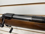 Used Savage 11030-06 wood stock with black receiver and barrel bore is clean good condition - 11 of 24