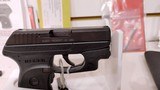 Used ruger LCP 2.5" barrel .380 cal crimson trace red dot built in soft holster lock manuals original box reduced - 15 of 20