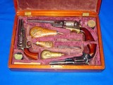 Triple Colt Cased Set, Colt Model 1851 Navy Revolver, Colt Model 5A,1855 Root Revolver, and  Colt Model 1849  Pocket Revolver With Accessories - 1 of 4