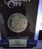 A collection of NGC
graded
Morgan Silver Dollars
& 1882-CC MS 64 GSA
Hoard with display tray - 2 of 5