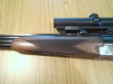 Heym 55 DBSS Sidelock Double Rifle with Animal Engraving in 9,3X74R-Zeiss Scope and Swing Mounts.
- 4 of 15