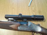 Heym 55 DBSS Sidelock Double Rifle with Animal Engraving in 9,3X74R-Zeiss Scope and Swing Mounts.
- 3 of 15