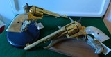 Pair of Colt 1st Gen. Single Actions Gold Finished Engraved Mother of Pearl Grips in 45 Cal. - 15 of 15