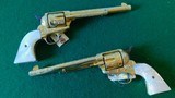 Pair of Colt 1st Gen. Single Actions Gold Finished Engraved Mother of Pearl Grips in 45 Cal. - 13 of 15