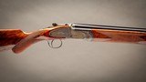 holland & holland 12 gauge 'sporting 'deluxemodel over and under shotgun with 30 inch barrels.