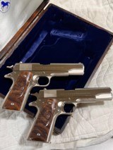 Cased pair of Colt 1911 Nickel pistols with presentation case.
.45 acp - 6 of 15