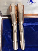 Cased pair of Colt 1911 Nickel pistols with presentation case.
.45 acp - 12 of 15