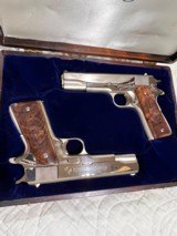 Cased pair of Colt 1911 Nickel pistols with presentation case.
.45 acp - 1 of 15