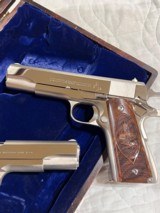 Cased pair of Colt 1911 Nickel pistols with presentation case.
.45 acp - 7 of 15