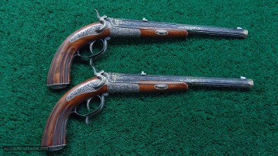 EXTRAORDINARY PAIR EXHIBITION GRADE RELIEF ENGRAVED GOLD INLAID TARGET PISTOLS