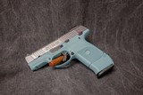 RUGER SR9c 9MM. TURQUOISE POLYMER FRAME & BRUSHED STAINLESS SLIDE - 2 of 3