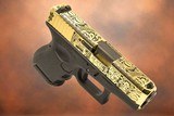 GLOCK EXCLUSIVE: G26, 9MM 24K GOLD PLATED WITH MAYAN AZTEC DESIGN 9MM LUGER (9X19 PARA)