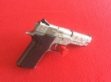 SMITH & WESSON MODEL 1076
10MM
DBL. ACTION AUTO PISTOL,
FULLY ENGRAVED - 1 of 5