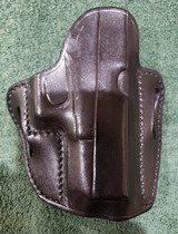 Alessi Hard Shell Talon IWB Holster for Glock 19/23
RH
Brown leather.
Brand new.
1990s Mfg. - 9 of 10