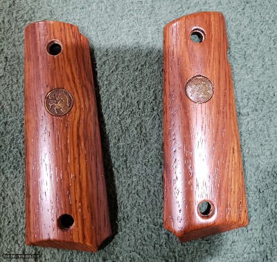 Colt 1911 Government and Commander size pistols.Wood grips with medallions.