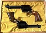 ST. LOUIS BICENTENNIAL COMMEMORATIVE COLT SINGLE ACTION .45 LC / .22 LR CALIBER REVOLVERS. A SCARCE TWO GUN SET. 250 TOTAL WERE MADE - 1 of 15