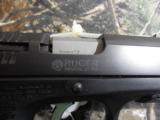 RUGER
P-95
9-MM,
LIKE
NEW,
2 -
15
ROUND
MAGAZINES,
COMBAT
SIGHTS,
THUMB
SAFTEY,
RAIL,
HARD
CASE. - 5 of 17