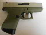 GLOCK
G- 43 USA
9MM, Cerakote
Forest
Green, Cerakote
Shimmering
Aluminum,
2- 6 RD.MAGS,
FACTORY
NEW
IN
BOX - 1 of 22