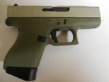 GLOCK
G- 43 USA
9MM, Cerakote
Forest
Green, Cerakote
Shimmering
Aluminum,
2- 6 RD.MAGS,
FACTORY
NEW
IN
BOX - 1 of 24