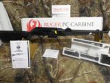 RUGER TACTICAL
Model PC
9-MM
CARBINE,
features interchangeable magazine wells,
Ruger and Glock magazines. NEW
IN
BOX - 4 of 24