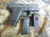 GLOCK
G-27
GENERATION - 3,
WHITE
SIGHTS,
PRE
OWNED,
3.5"
BARREL, 1-11 & 1-9
ROUND
MAGAZINE,
AND
GLOCK
PLASTIC
HARD
CASE. WITH
M - 6 of 18