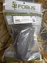 GLOCK
HOLSTERS, G- 19, 23, &, 32,
FOBUS
TACTICAL,
PADDLE
HOLSTER,
RIGHT
HAND,
GLOCK
GUNS
WITH
LASERS
OR
LIGHTS
ON
RAIL, NEW IN BOX. - 1 of 19