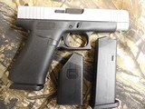 GLOCK
48,
THE JUST OUT GLOCK 48,
9-MM
LUGER FS 10-SHOT BLACK FRAME SILVER SLIDE,
2- MAGAZINES,
4"
BARREL,
FACTORY
NEW
IN
BOX. - 5 of 22