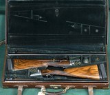 John Dickson & Sons --- Consecutive pair, Round Action Shotguns --- 12 Gauge, 2 3/4