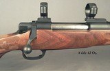 McMILLAN 280 REM. SIGNATURE MOD- WALNUT STOCK and a COMPOSITE STOCK- WILL SHOOT 1/2