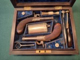 CASED PAIR OF SCREW BARREL, FOLDING TRIGGER, PERCUSSION MUFF PISTOLS - 1 of 15